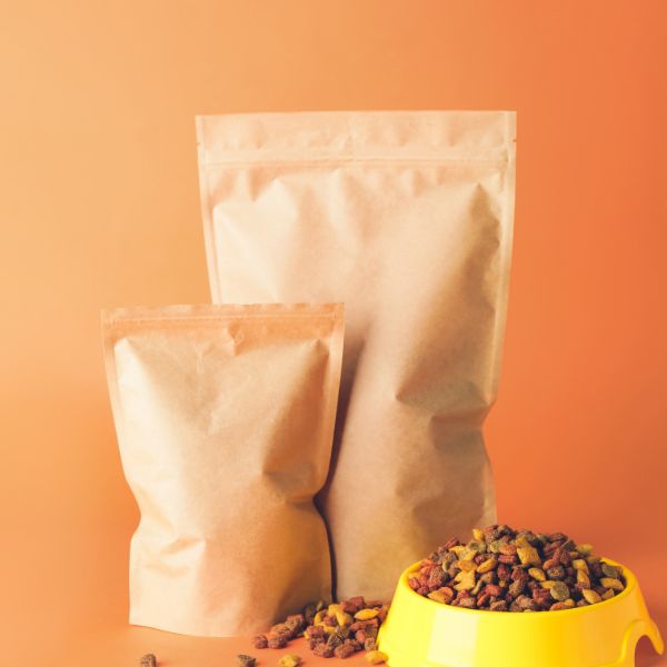 Pet food bags with kibble in a bowl